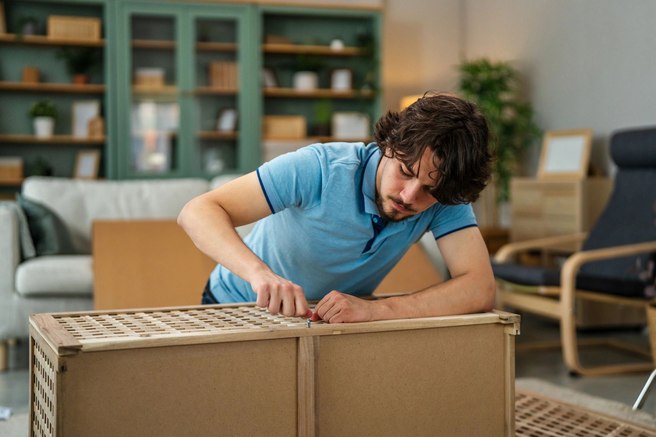 Technician assembling flat-pack furniture in a modern home